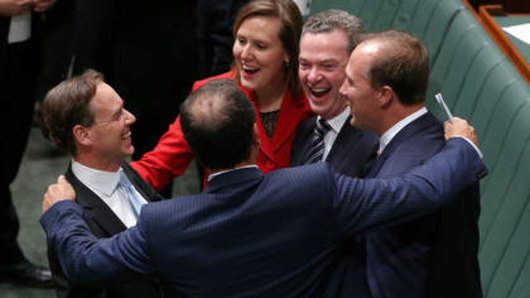 Then Environment Minister Greg Hunt congratulated by colleagues after the Abbott government succeed in scrapping the carbon price in 2014. Kelly O'Dwyer, Christopher Pyne, Peter Dutton and Mal Brough (back to the camera).