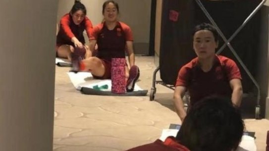 The Chinese soccer team goes through their paces in the corridors of the Westin in Brisbane.