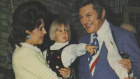 Lady Mary Fairfax with children Charels and Anna present a bouquet to Liberace.