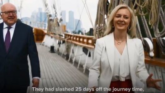 Australia's High Commissioner to the UK, George Brandis, with UK Trade Secretary Liz Truss in the video.
