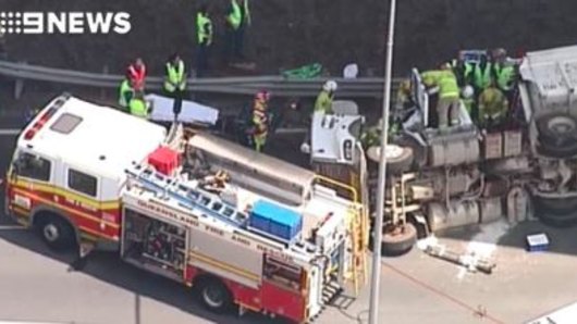Crews were working to free the truck driver after a rollover near Brisbane Airport on Tuesday afternoon. Credit: Nine News.