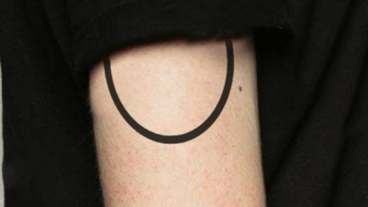 An image of the man's upper-arm tattoo, as described by the victim, has also been released by police.