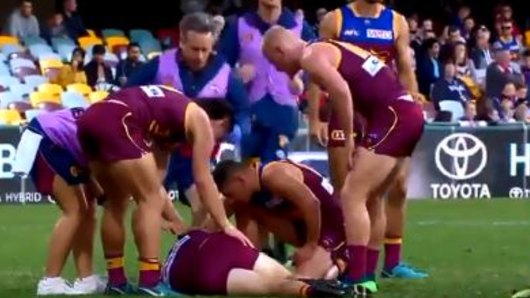 Lions players check on Andrews after the collision.