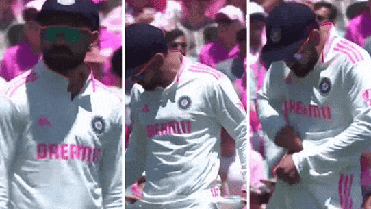 Virat Kohli makes sandpaper gestures.