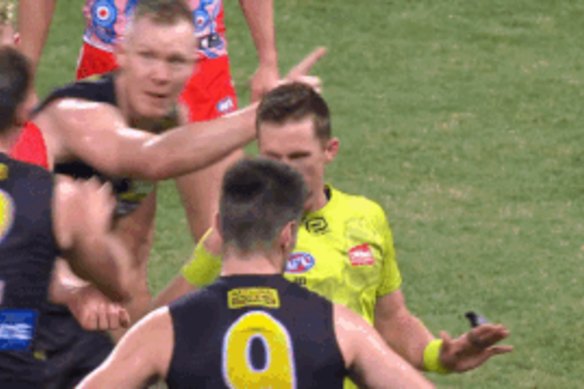 Umpire Matt Stevic makes his call following the final siren.