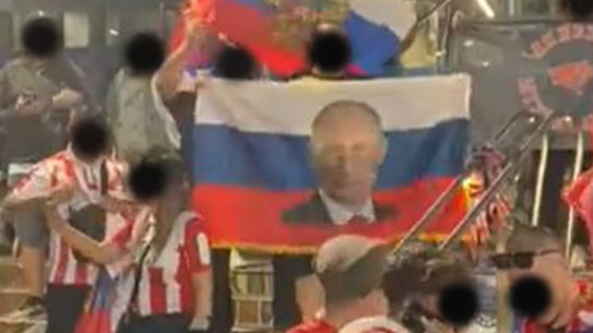Screenshot of Russian fans carrying the national flag at Melbourne Park. Faces have been blacked out.