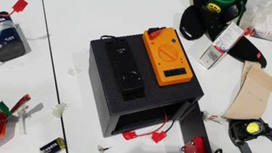 The device/item that the man had with him at the Brisbane Airport incident. 