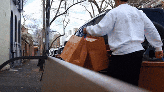 Joseph Suaalii takes his Louis Vuitton bags to his parked Defender in Surry Hills. 