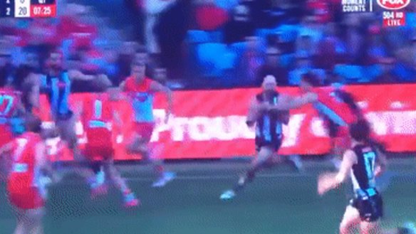 Collingwood star Steele Sidebottom is spun around in a tackle but ‘play on’ is the call.