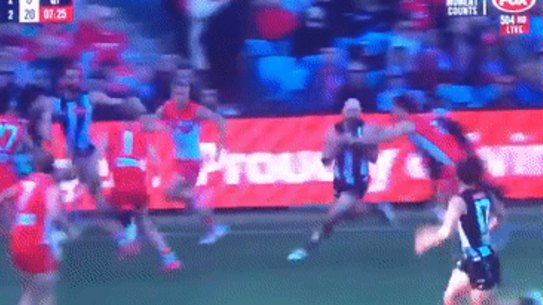 Collingwood star Steele Sidebottom is spun around in a tackle but ‘play on’ is the call.
