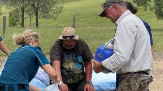 Robert Weber, 58, is checked over by paramedics after being found by Gympie MP Tony Perrett on Sunday morning.