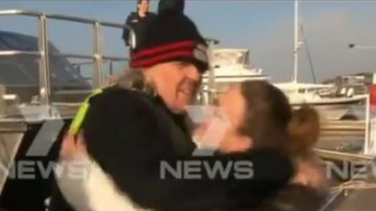 The man is reunited with his family after spending a night on the bay. 
