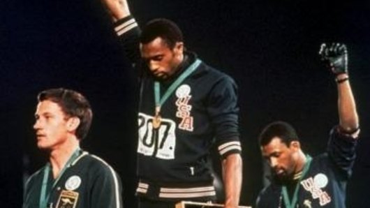 Australia's Peter Norman (left) joins American athletes Tommie Smith and John Carlos on the podium during the famous "Black Power" demonstration in 1968.