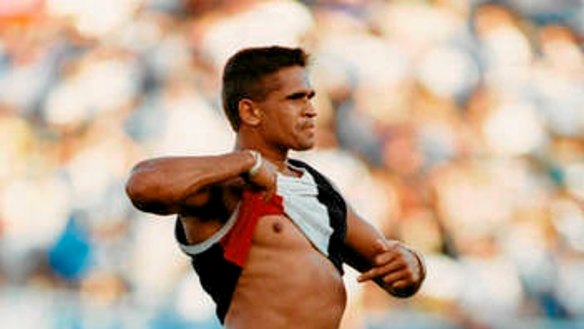 St Kilda footballer Nicky Winmar raises his jumper in response to racial taunts from Collingwood fans at Victoria Park in 1993.