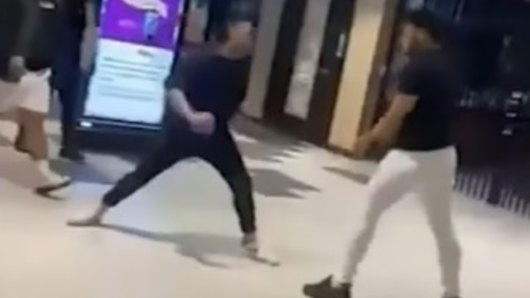 The victim’s friend (dressed in all black) appears to taunt the alleged stabber (in white trousers). The victim is not in the picture.