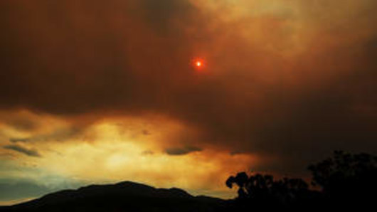 Clouds from a nearby bushfire are seen over Mount Wellington in Tasmania. 