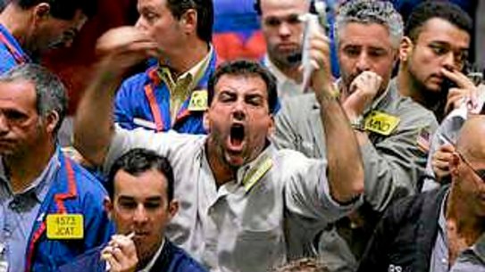 Crude oil futures traders work on the floor of the Mercantile exchange in New York City. 