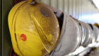 Dirt-covered safety helmets hang on hooks at the Sandfire Resources NL copper operations at DeGrussa, 559 miles (900 kilometers) north of Perth, Australia, on Sunday, Aug. 4, 2013.