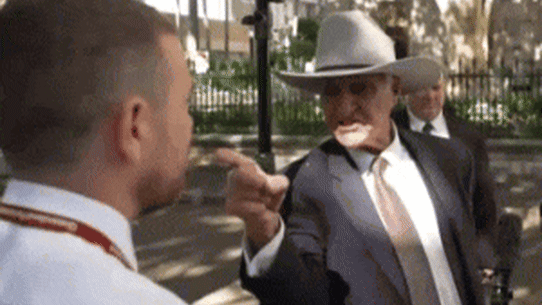 Bob Katter confronts a journalist in Brisbane.