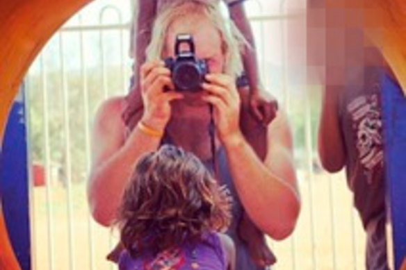 Tait photographing an Indigenous child in central Australia. He worked at a centre in the APY Lands.