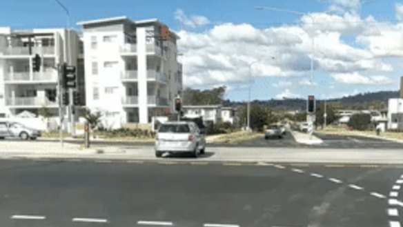 A car stops on a red light on the light rail tracks at Mitchell.
