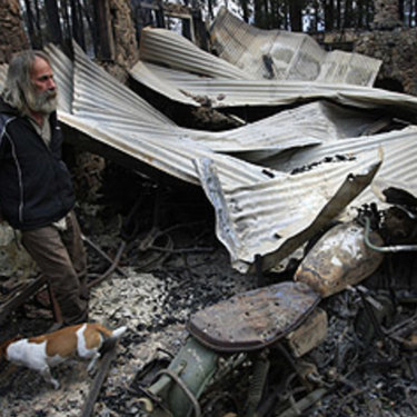 Rob Hallett and his dog Ted in the ruins of the shed.