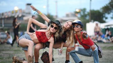 (L-R) Model Hanne Gaby Odiele wearing denim shorts, a cowboy hat and cowboy boots poses with Anna Ewers and guest at the 2016 Panorama NYC Festival at Randall's Island on July 22, 2016 in New York City.