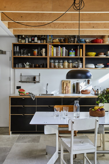 Space was saved in the kitchen by not having a dishwasher or range hood and by using double drawers. An induction cooktop also doubles as bench space. 