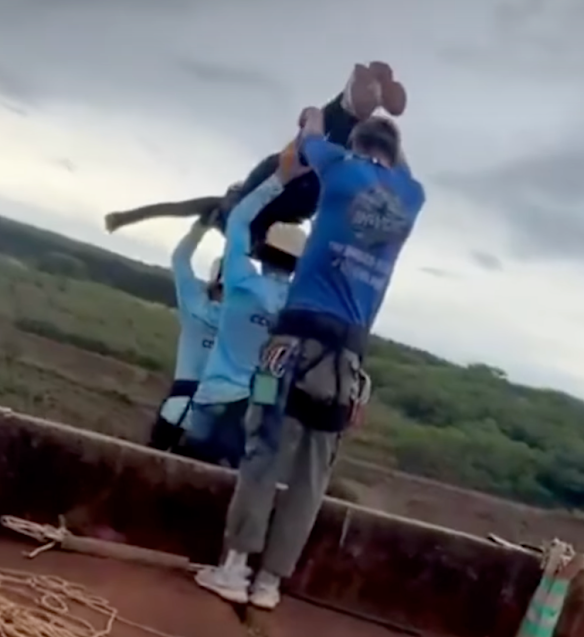 The rope appears to be lying on the ground as the woman is preparing to jump.
