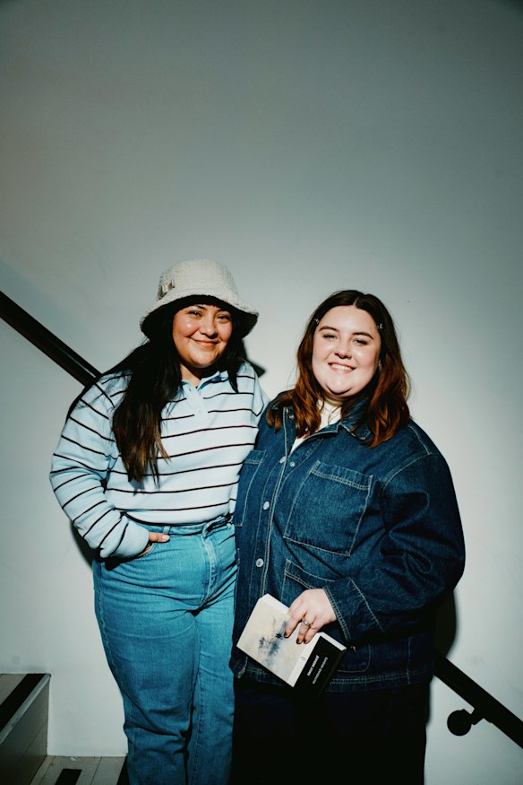 Roommates Fatima Calderon and Emma Keithley, holding her copy of Wuthering Heights, at the read-in.