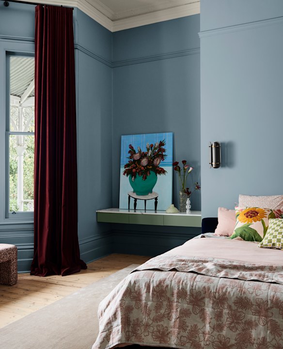 Classic does not always mean neutral. Artwork picks up on deep crimson velvet curtains in this room painted in Dulux Clouded Sky. Styling by Bree Banfield 