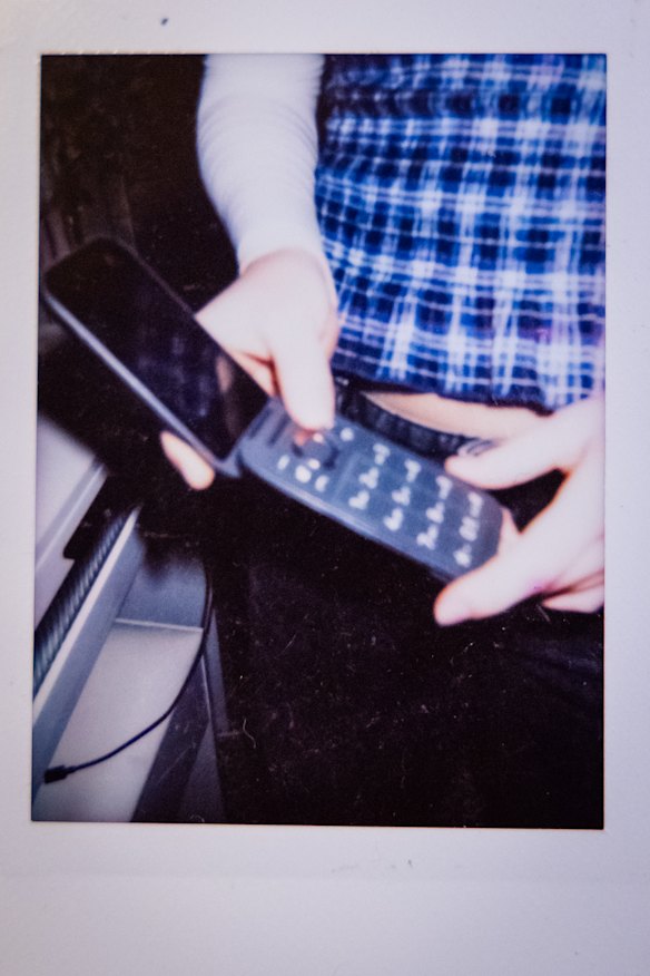 Olive’s flip phone, captured on a polaroid.