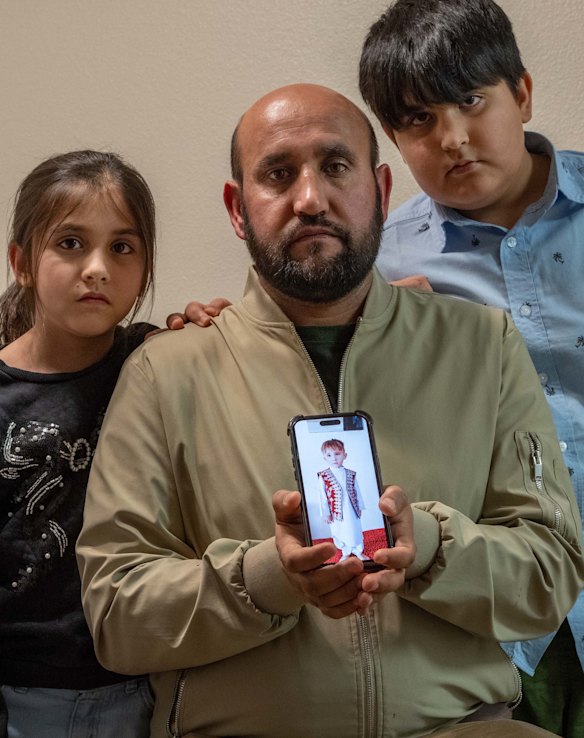 Sayed Rasool Hashemi, with his daughter, Kawsar, and son Sayed Asadullah, in the family’s Oregon apartment, with a photo of youngest child, Sayed Anas.