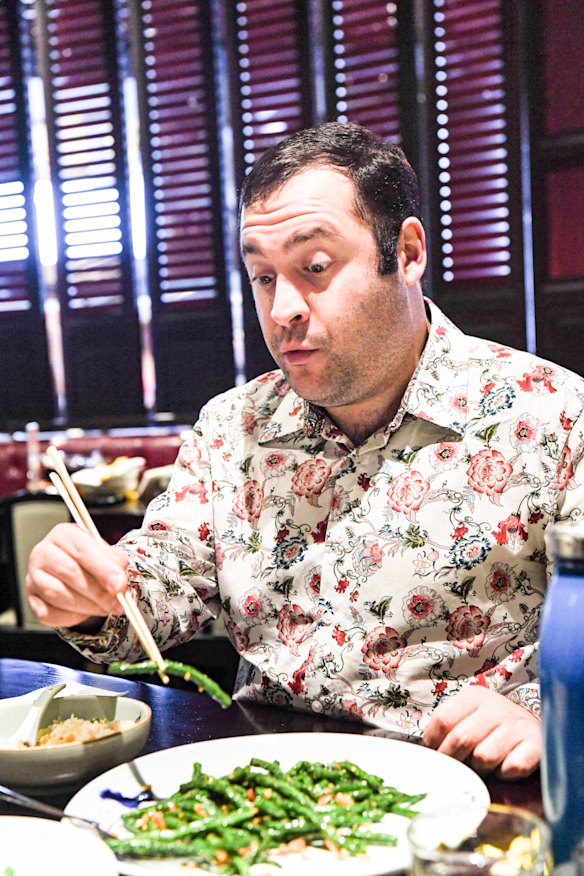 Michael Theo digs into New Shanghai’s string beans with shrimp and soy sauce. 