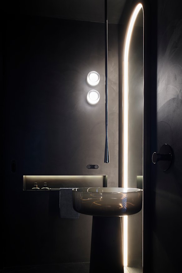 Not everyone has the budget to splash out on a statement basin but a moody paint colour in the powder room sets an elegant tone.