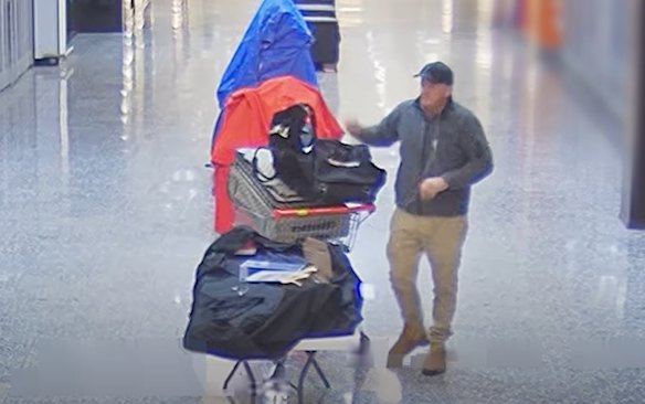 CCTV footage shows an unknown man collecting shoes at Kenmore Village Shopping Centre.