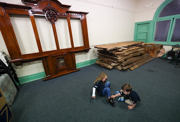  George, 2, and Elizabeth, 4, in front of gifted timber that will one day be the sub-branch’s bar.