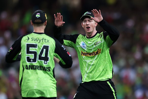 Hugh Weibgen celebrates taking a catch for the Sydney Thunder last summer.