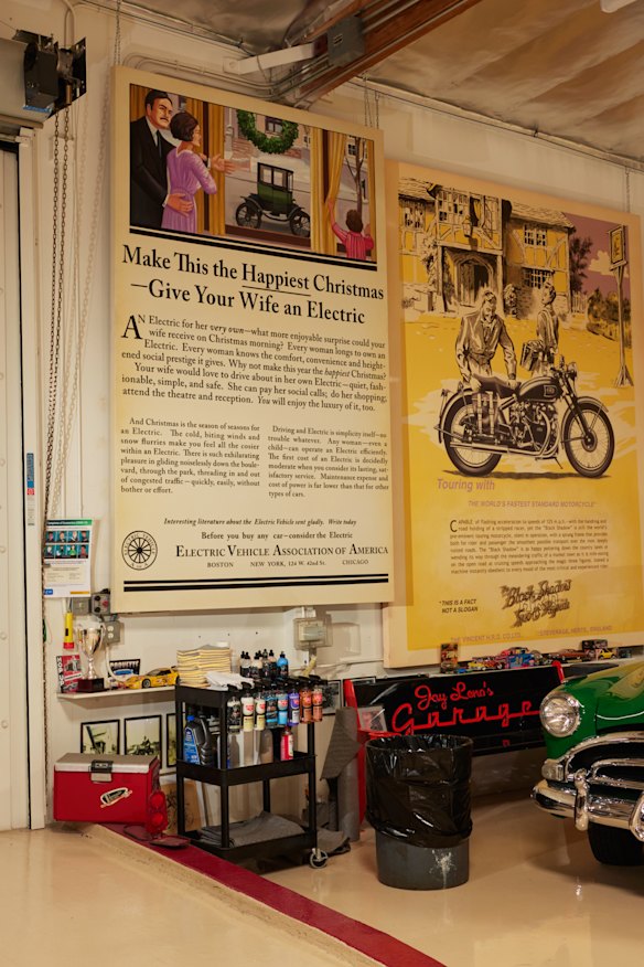 A reproduction of an ad, left, for one America’s first electric vehicles, on the walls of Jay Leno’s collection.