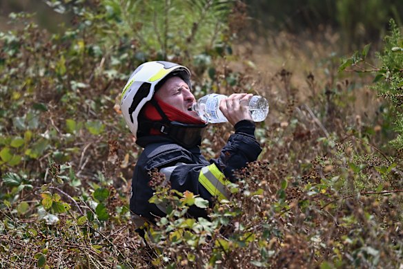 A firefighter takes a break while battling a wildfire near Le Temple, outside Bordeaux.