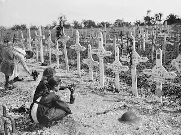 French children tending the graves of fallen Australians at Adelaide Cemetery, Villers-Bretonneux.