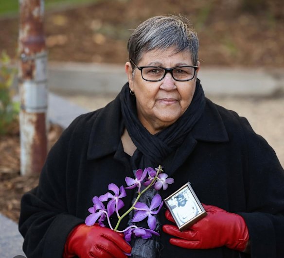Indigenous woman Roslyn Sultan holds a photo of her mother Loretta. 
