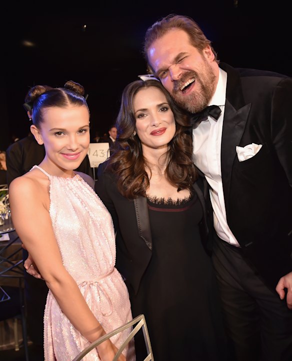 Brown and Harbour, pictured here in 2018 with co-star Winona Ryder, first met on the set of Stranger Things in 2015, when Brown was 11 years old.