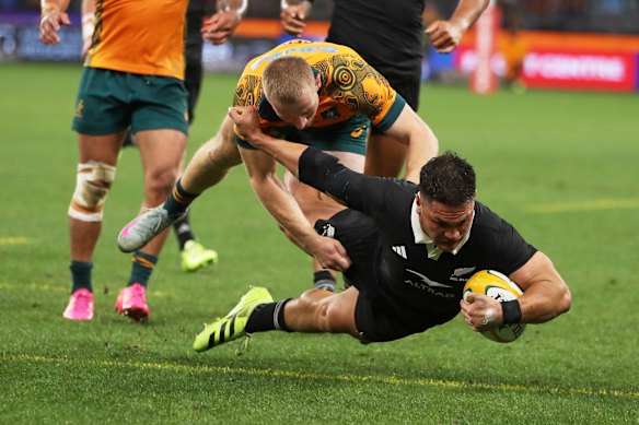 New Zealand’s Quinn Tupaea dives over the line to score a try.