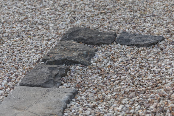 Old bluestone edging has been paired with gravel.