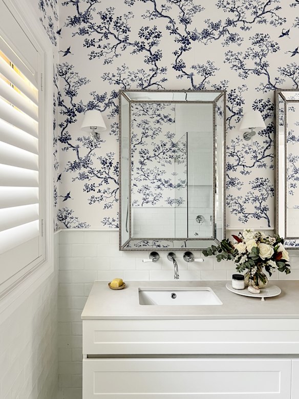 Fresh, fragrant flowers are always a good idea in the bathroom. Patterned wallpaper takes this space from ordinary to elevated.