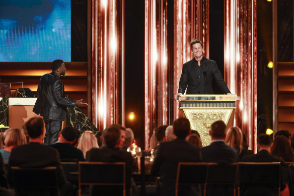 Funny (sort of): Kevin Hart and Tom Brady chat on stage during Brady’s roast on Netflix.
