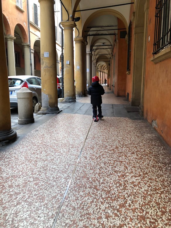 Banham’s son on his zippy “monopattino” on a smooth Bologna portico.