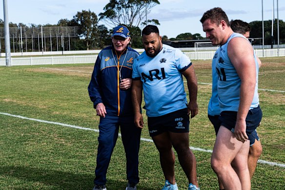Taniela Tupou at a Waratahs training session in Sydney, with scrum coach Mike Cron and Angus Bell.