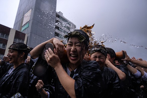 Participants carry a mikoshi, or portable shrine, during the Fukagawa Hachiman Matsuri in Tokyo, Japan.